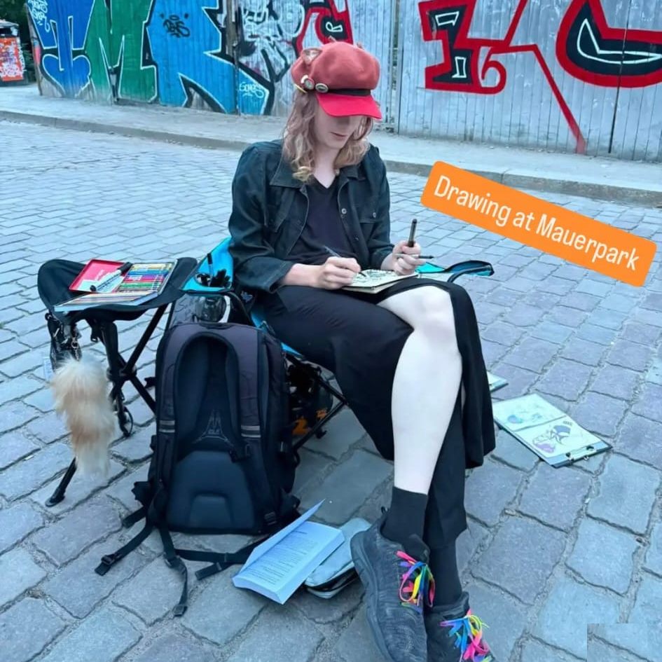 Aydan drawing outdoors at Mauerpark