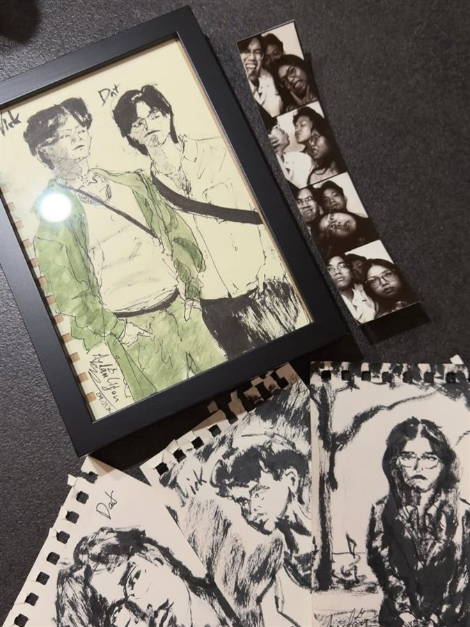 Framed portrait of a couple in fineliner and green watercolour, next to more ink sketches of the two and a photo strip