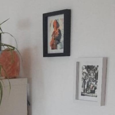 The same portrait, now framed on the wall at his home