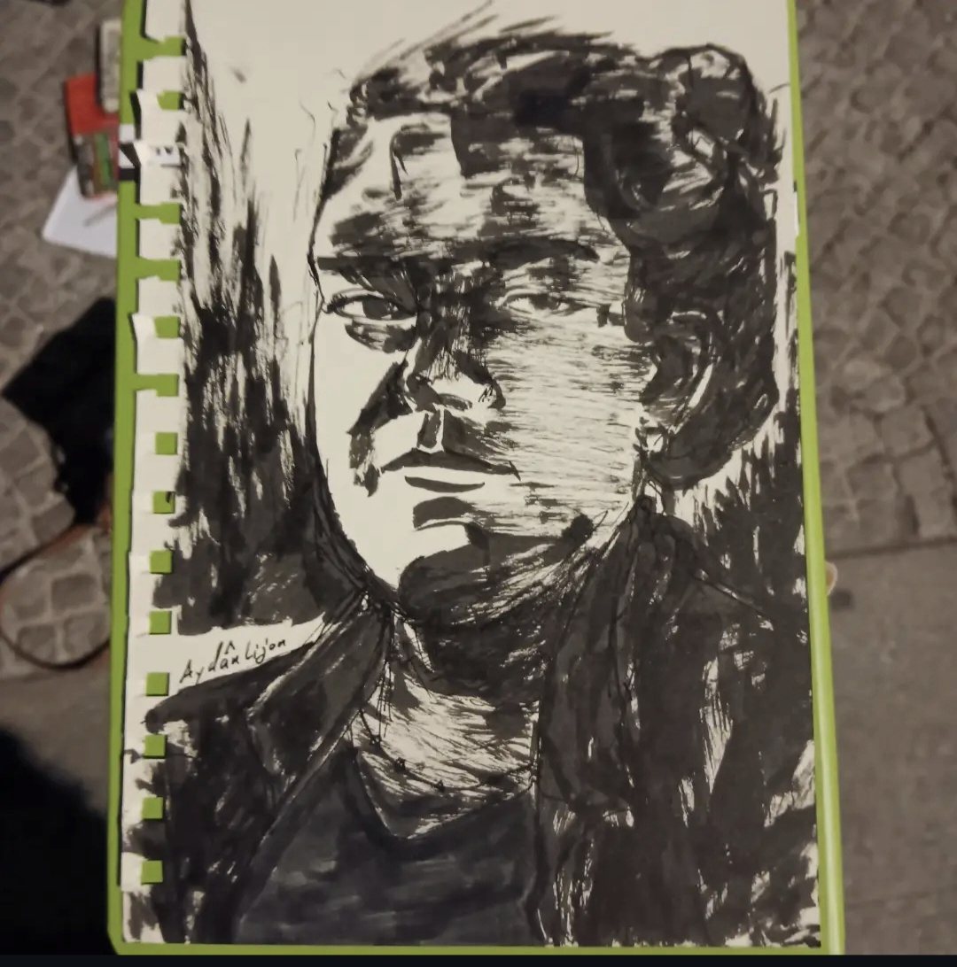 Serious ink portrait in a sketchbook