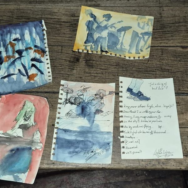Delicate watercolour sketches on a wooden table