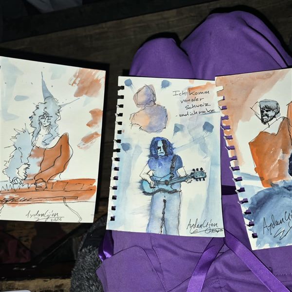 Three watercolour sketches in hands